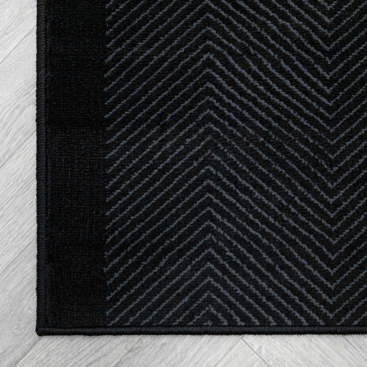Dancette Border Black rug corner