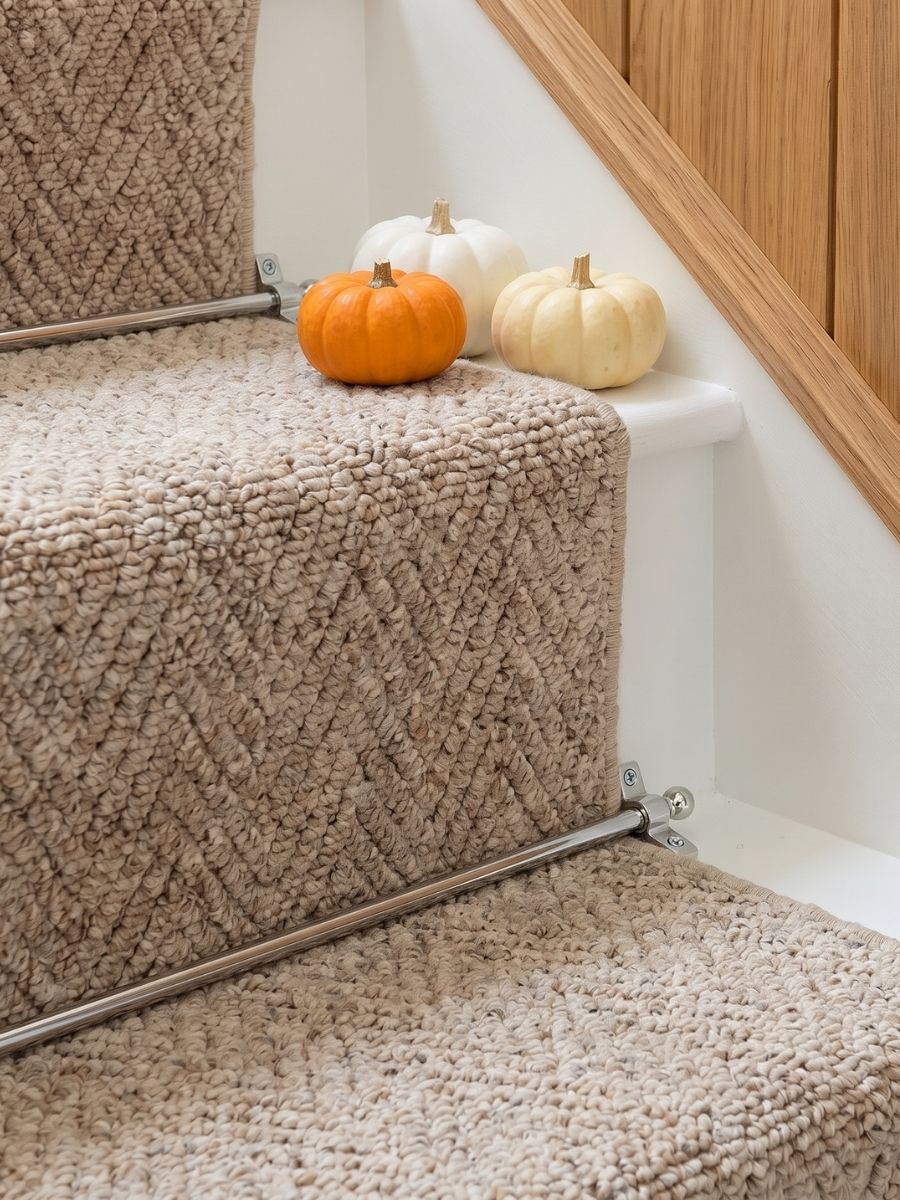 Chrome stair rods on a herringbone stair runner